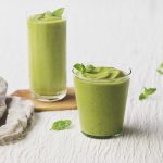 Two glasses of tropical green avocado smoothie