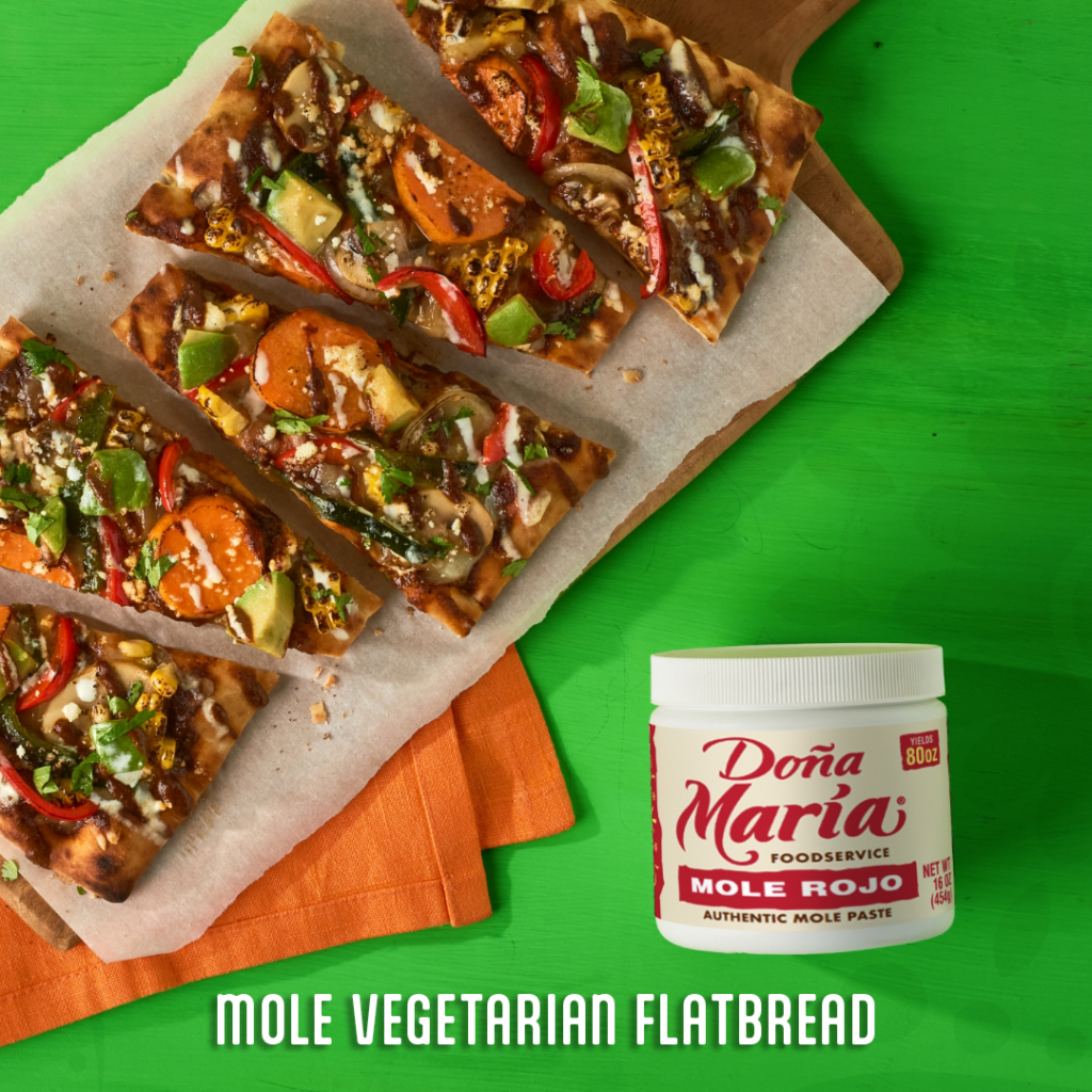 mole veggie flatbread on a tray next to a container of Dona Maria mole rojo