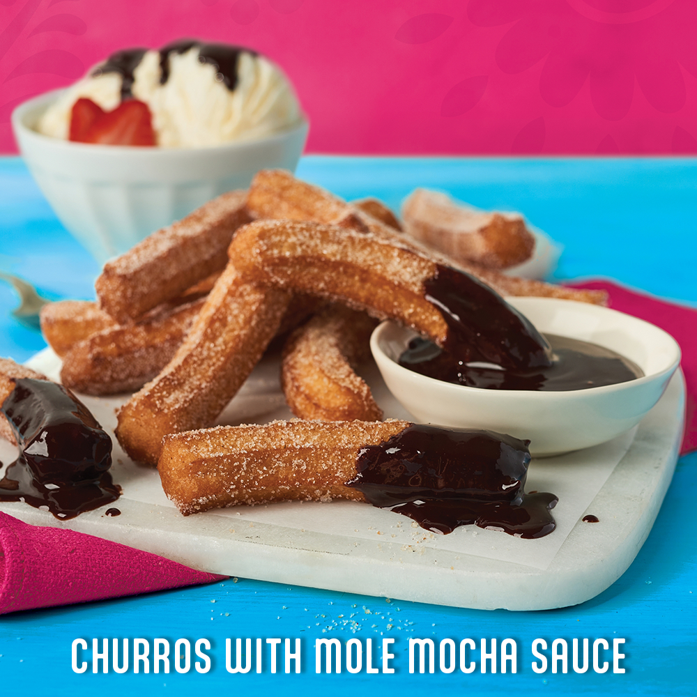 a tray of churros with mole mocha sauce