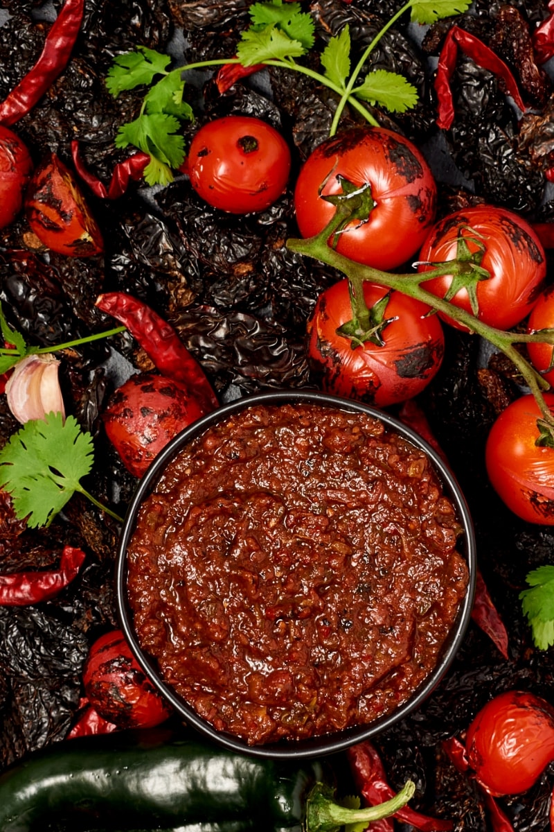 Salsa Chipotle in a bowl on a bed of charred veggies