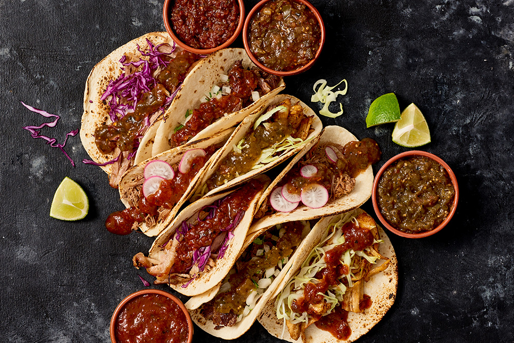 Tacos with sides of quemada charred salsas, in 4 flavors.